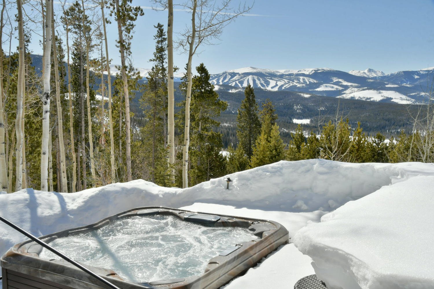 Outdoor Hot Tub with Mountain Views in Our Winter Park Escapes Rental.
