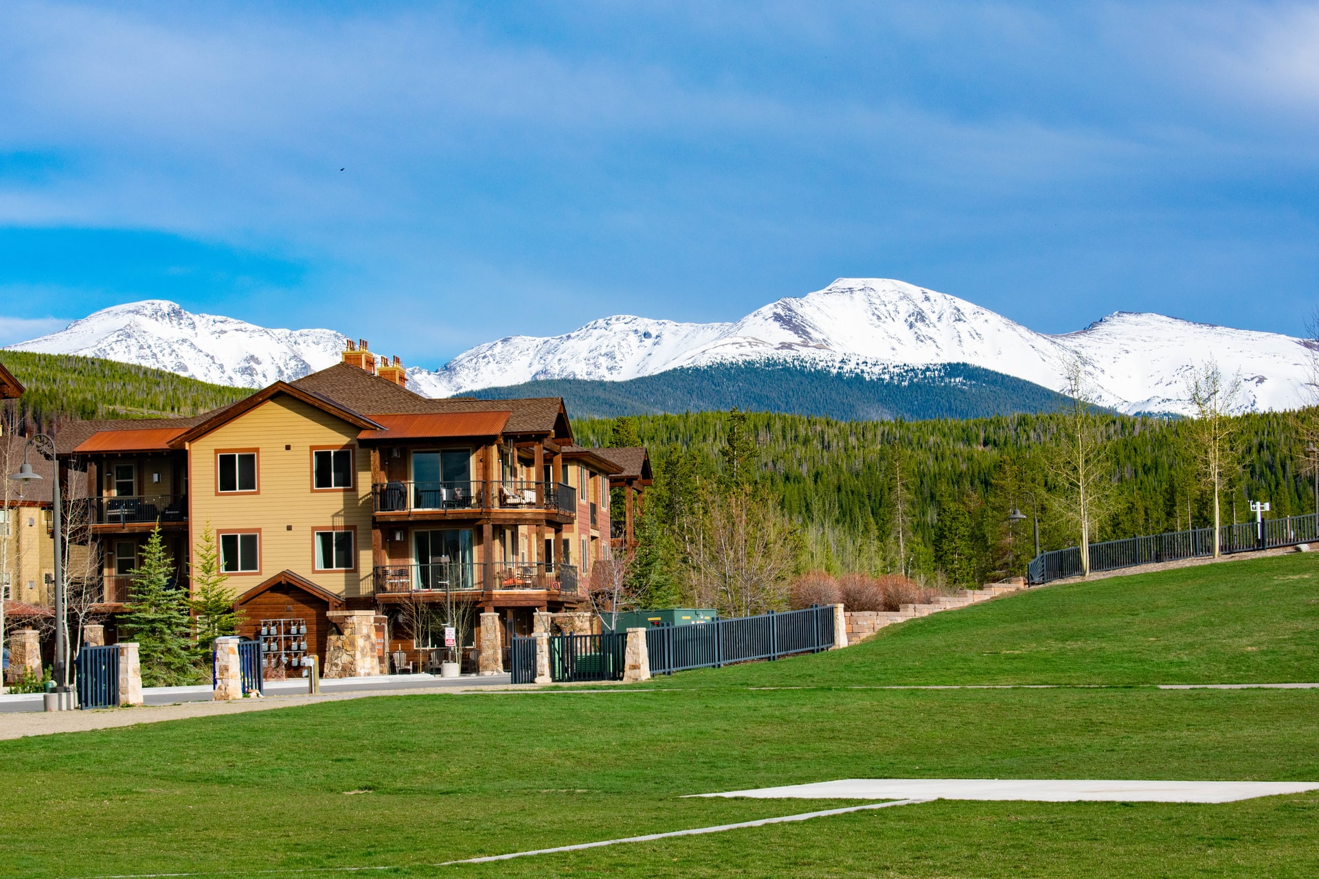 condominium on field with mountains behind
